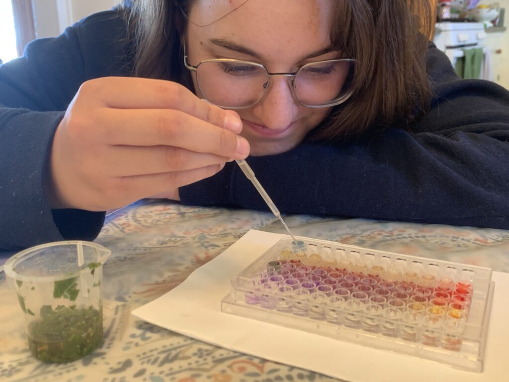 Teen girl testing acids and bases