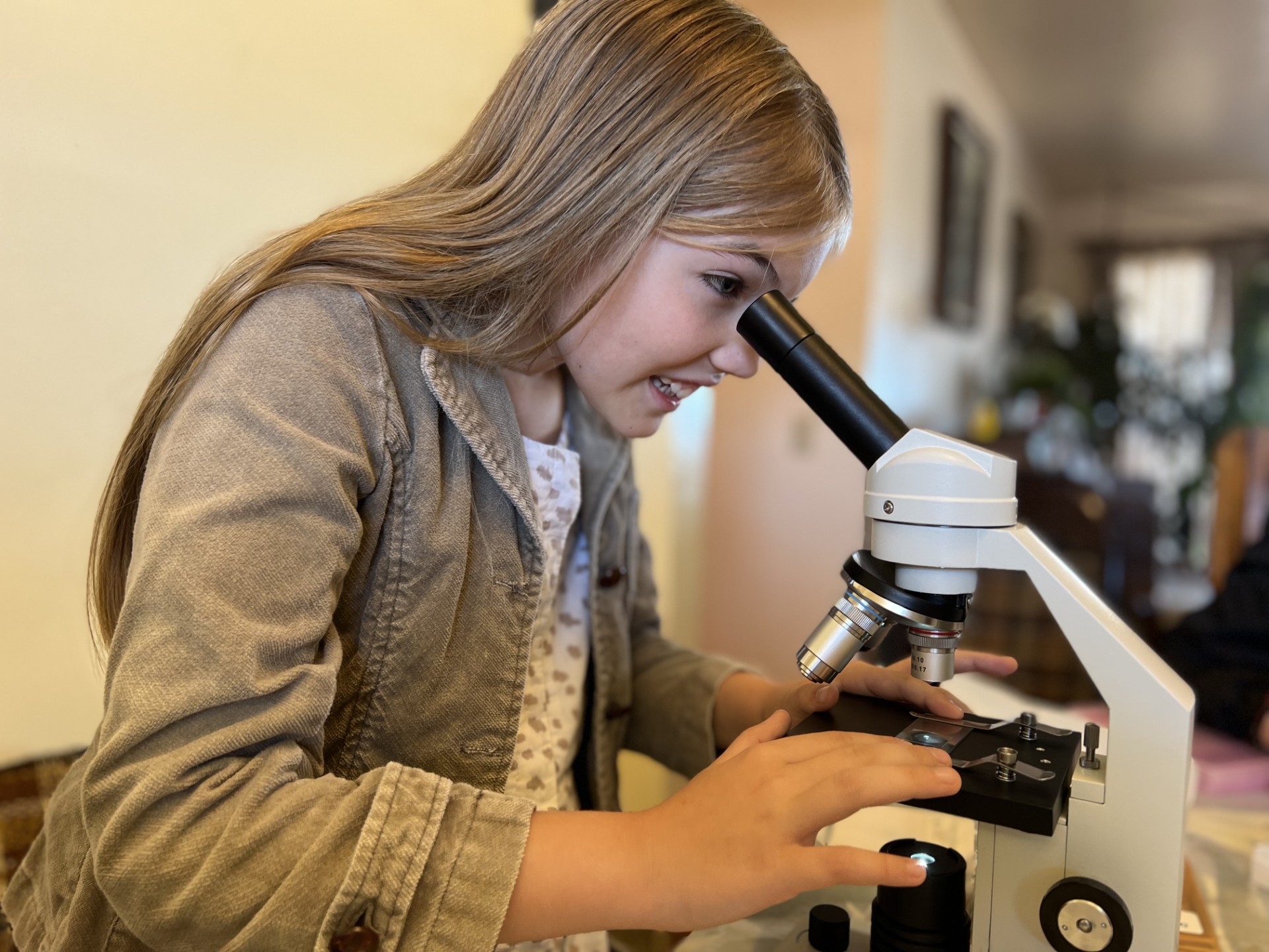 Student using a microscope during a Lab Rat Academy life science lab.